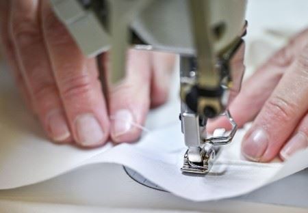 Sewing machinist working with fabric
